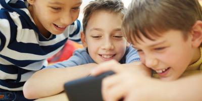 Kids  looking at a smartphone