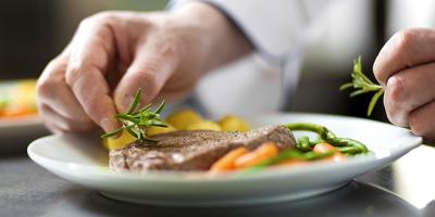 Food being arranged on a plate