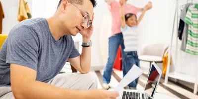 Man working on laptop looking stressed