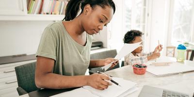 Mom prepares taxes while toddler plays