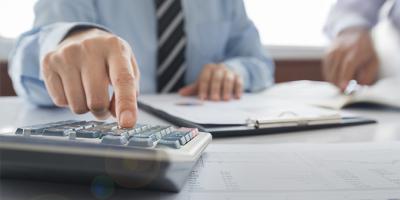 Man using calculator on a desk