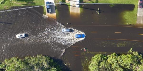 Flood water through a neighborhood.  