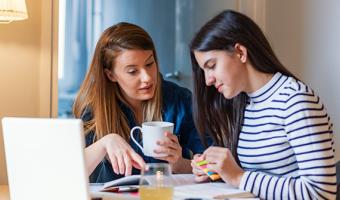 Woman talking to her teen daughter about finances