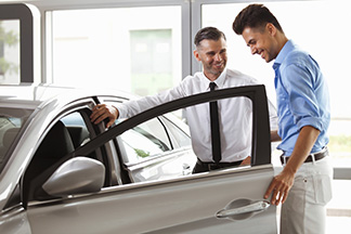 man buying a new car from a salesman