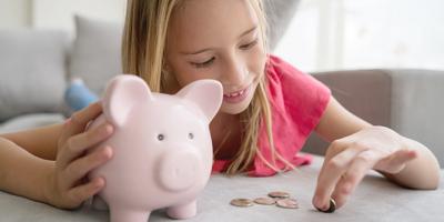 Girl with piggy bank and change